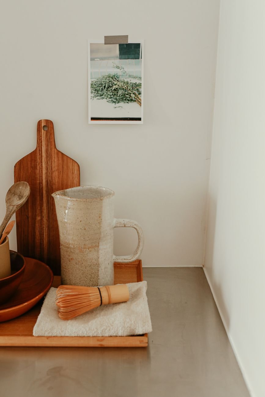 Aesthetic wooden kitchen setup with a ceramic pitcher providing warm rustic vibes.
